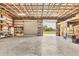 Spacious garage with high ceilings, metal framing, and roll-up doors providing access to the outdoors at 3045 Logue Rd, Myakka City, FL 34251