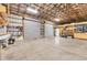 Expansive garage with ample storage, metal framing, and roll-up doors for convenient access at 3045 Logue Rd, Myakka City, FL 34251