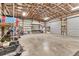 Spacious garage with high ceilings, metal framing, and roll-up doors, offering storage and workspace at 3045 Logue Rd, Myakka City, FL 34251