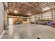 Spacious garage featuring exposed wood beam ceilings, ample storage, and a concrete floor at 3045 Logue Rd, Myakka City, FL 34251