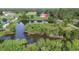 Expansive pond and grounds featuring mature trees and outbuilding with road access at 3045 Logue Rd, Myakka City, FL 34251