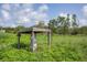 Well with a wooden roof in a grassy field at 3045 Logue Rd, Myakka City, FL 34251