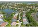 Aerial view of a residential neighborhood featuring lakefront homes, private docks, and lush landscaping at 315 36Th Ne St, Bradenton, FL 34208