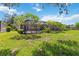A spacious, well-maintained backyard features lush greenery and a screened-in patio area at 315 36Th Ne St, Bradenton, FL 34208