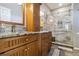 Updated bathroom with marble countertops, wood cabinets, and a marble-tiled shower at 315 36Th Ne St, Bradenton, FL 34208