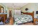 Serene bedroom with wood floors, a decorative comforter, and a barn door to the en-suite bathroom at 315 36Th Ne St, Bradenton, FL 34208