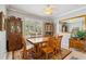 Traditional dining room with wooden table, chairs, and natural light from a large window at 315 36Th Ne St, Bradenton, FL 34208