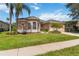 Inviting single Gathering home showcasing a manicured lawn and beautiful landscaping on a bright, sunny day at 315 36Th Ne St, Bradenton, FL 34208