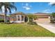 Charming single Gathering home featuring a manicured lawn and inviting curb appeal on a sunny day at 315 36Th Ne St, Bradenton, FL 34208