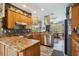 Well-equipped kitchen featuring wood cabinets, granite countertops, and stainless steel appliances at 315 36Th Ne St, Bradenton, FL 34208