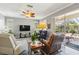 Bright living room with hard surface flooring, ceiling fan, and a large sliding door to the outdoor patio at 315 36Th Ne St, Bradenton, FL 34208