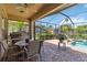 Relaxing screened patio with ceiling fan, outdoor kitchen, and a view of the pool at 315 36Th Ne St, Bradenton, FL 34208