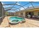 Sparkling in-ground pool and spa are encased in a screened enclosure with a brick patio at 315 36Th Ne St, Bradenton, FL 34208