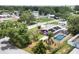 Lovely residence showcasing mature landscaping, a screened pool, and solar panels, offering a serene retreat at 3240 6Th St, Sarasota, FL 34237