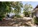 Secluded backyard with a grill, patio seating, and privacy fence surrounded by palm trees at 3240 6Th St, Sarasota, FL 34237