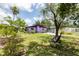 Secluded backyard showcasing a unique painted home, lush landscaping and an inviting pool area at 3240 6Th St, Sarasota, FL 34237