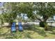 Landscaped backyard featuring a lawn, trees, and outdoor seating, perfect for relaxation at 3240 6Th St, Sarasota, FL 34237
