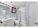 Bathroom with a vanity, framed mirror, and a walk-in shower with glass doors at 3240 6Th St, Sarasota, FL 34237