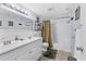 Well-lit bathroom featuring a double sink vanity, shower-tub combo, and neutral finishes at 3240 6Th St, Sarasota, FL 34237