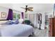 Bedroom featuring a fan, grey walls, large windows, and ensuite access at 3240 6Th St, Sarasota, FL 34237