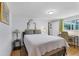 Bedroom with a simple bed, desk, and window overlooking the trees at 3240 6Th St, Sarasota, FL 34237