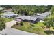 Aerial view of a purple single-Gathering home with a large yard, pool and screened-in porch, surrounded by lush trees at 3240 6Th St, Sarasota, FL 34237