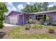 This home offers a manicured front yard with mature landscaping and an attached garage at 3240 6Th St, Sarasota, FL 34237