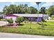 Lovely home with a well-manicured lawn and mature trees, offering great curb appeal at 3240 6Th St, Sarasota, FL 34237