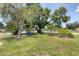 This property has a well-maintained front yard featuring lush greenery and a shaded seating area at 3240 6Th St, Sarasota, FL 34237