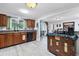 Kitchen featuring a window with sink and breakfast bar to the dining room at 3240 6Th St, Sarasota, FL 34237