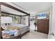 Spacious main bedroom with a four-poster bed, TV, and dresser near the bright windows at 3240 6Th St, Sarasota, FL 34237