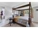 Bright main bedroom with a four-poster bed, side table, and calming natural light at 3240 6Th St, Sarasota, FL 34237