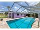 Sparkling in-ground pool with screened enclosure, perfect for outdoor entertaining and relaxation at 3240 6Th St, Sarasota, FL 34237