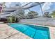 Enclosed pool area with a clear blue pool and comfortable lounge space at 3240 6Th St, Sarasota, FL 34237