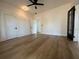 Bedroom with wood-look floors, white trim, a ceiling fan, and neutral walls at 3429 37Th N St, St Petersburg, FL 33713