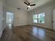 Bright bedroom featuring hardwood floors, a ceiling fan, and two large windows allowing ample natural light at 3429 37Th N St, St Petersburg, FL 33713