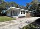 Charming single-story home with well-maintained lawn, shade trees, light gray paint, and inviting front porch at 3429 37Th N St, St Petersburg, FL 33713