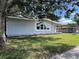 Well-maintained single-story home with light gray paint, green lawn, shade tree, and large window at 3429 37Th N St, St Petersburg, FL 33713