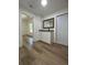 Hallway with wood-look floors, white trim, and a granite topped cabinet at 3429 37Th N St, St Petersburg, FL 33713