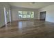 Bright living room featuring wood-look floors, white trim, and a wall of windows at 3429 37Th N St, St Petersburg, FL 33713