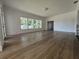 Bright living room featuring wood-look floors, white trim, and a wall of windows at 3429 37Th N St, St Petersburg, FL 33713
