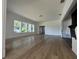 Bright living room featuring wood-look floors, white trim, and a wall of windows at 3429 37Th N St, St Petersburg, FL 33713