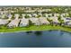 Aerial view of waterfront homes with screened lanais and lush green lawns along a serene lake at 3671 Summerwind Cir, Bradenton, FL 34209