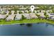Aerial view of a residential neighborhood showcasing well-manicured lawns and a tranquil lake at 3671 Summerwind Cir, Bradenton, FL 34209