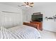 Bedroom featuring a bed, dresser, closet, and neutral tones at 3671 Summerwind Cir, Bradenton, FL 34209