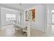 Stylish dining area with modern art, a contemporary chandelier, and a view to the outside at 3671 Summerwind Cir, Bradenton, FL 34209