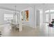 Stylish dining area with modern art, a contemporary chandelier, and a view to the entrance at 3671 Summerwind Cir, Bradenton, FL 34209