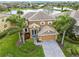 Beautiful home with a tile roof, well-maintained landscaping, and a paver driveway with a lake view in the background at 3671 Summerwind Cir, Bradenton, FL 34209