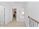 Second floor hallway with carpeted floor leading to bedrooms at 3671 Summerwind Cir, Bradenton, FL 34209