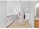 Bright hallway with carpet, iron railing, and an open view to other rooms at 3671 Summerwind Cir, Bradenton, FL 34209